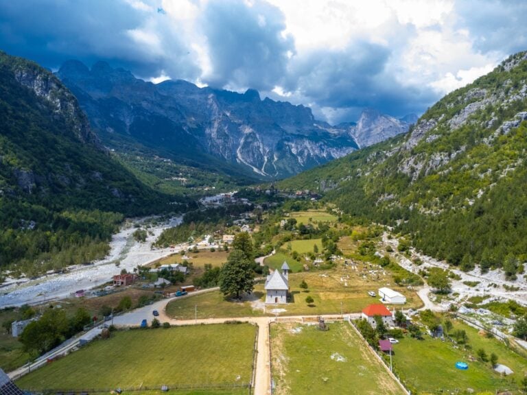 Aerial view of the small Catholic church in a valley of the Albanian Alps