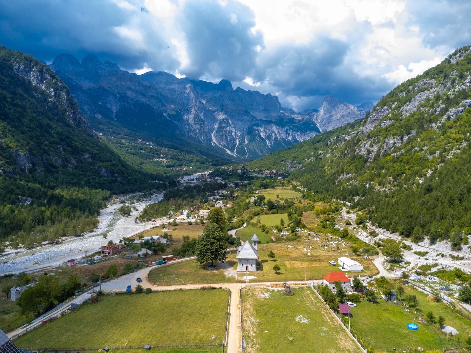 Aerial view of the small Catholic church in a valley of the Albanian Alps