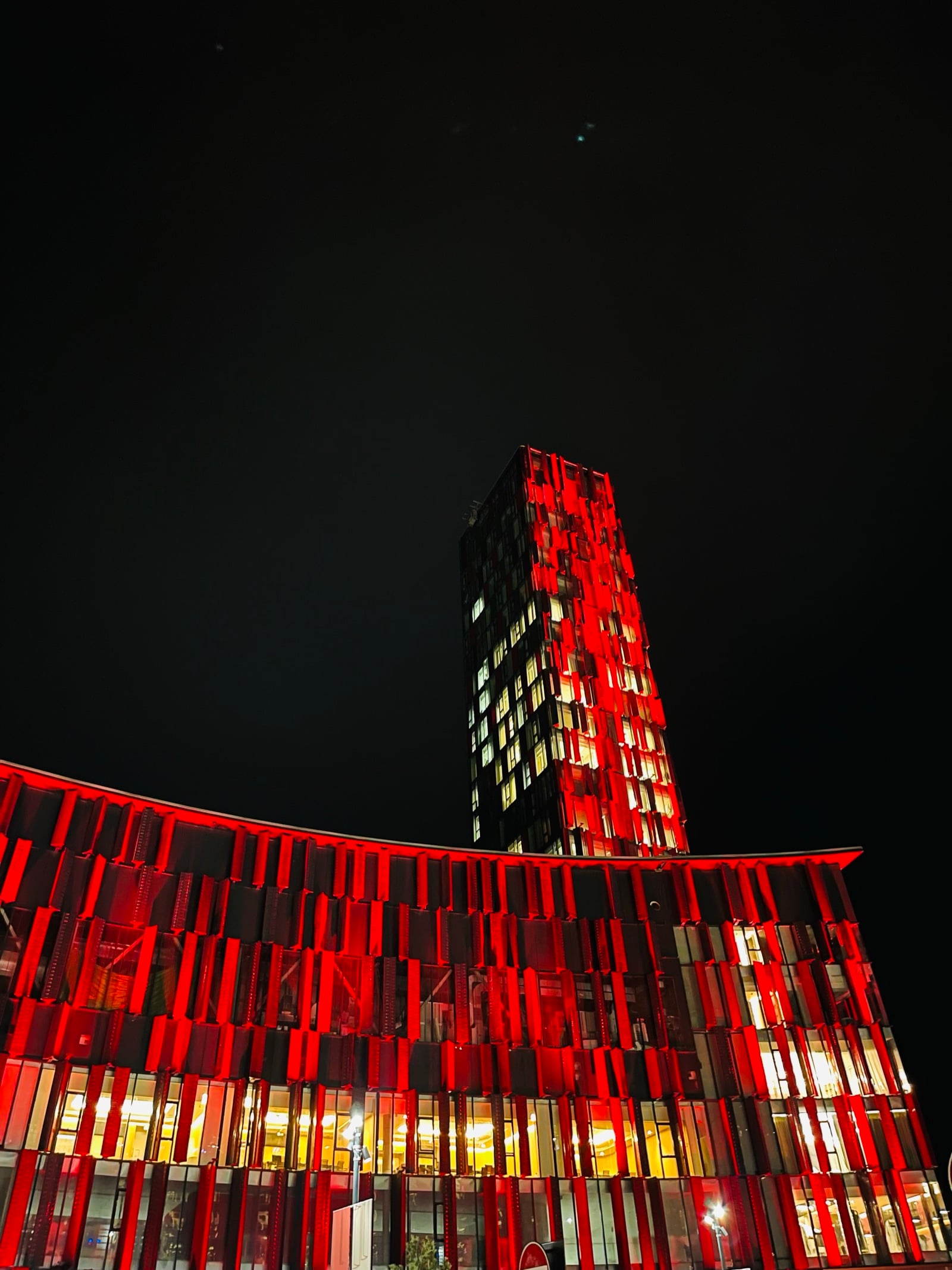 Tower of the national stadium in Tirana, Albania, lit in red at night
