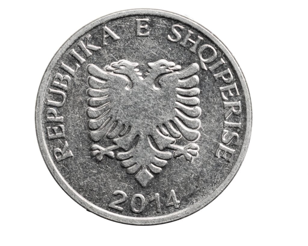 Albanian five lekë coin on a white background
