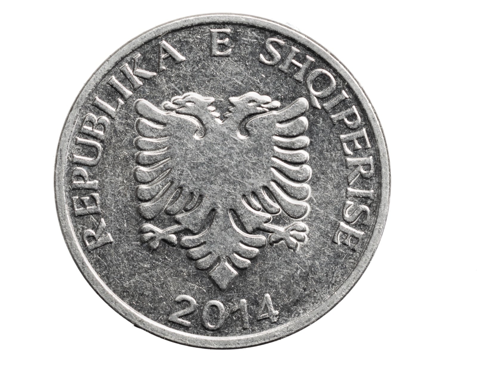 Albanian five lekë coin on a white background