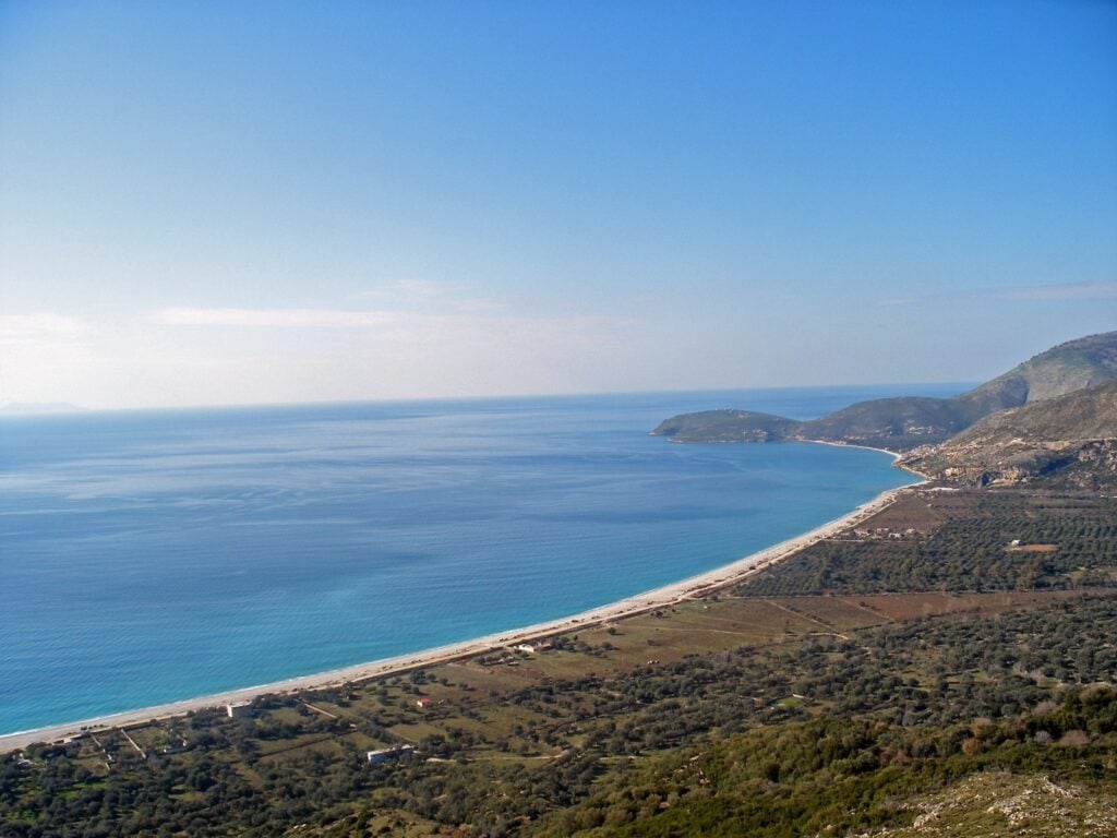 Long curving bay and beach of Borsh on the Albanian Riviera, seen from the hills above the olive groves