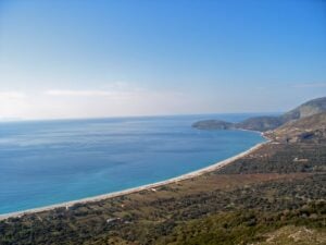 Long curving bay and beach of Borsh on the Albanian Riviera, seen from the hills above the olive groves