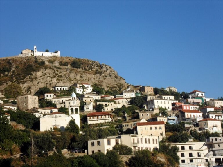 Old village of Dhërmi, Albania, with stone houses and churches climbing the hillside