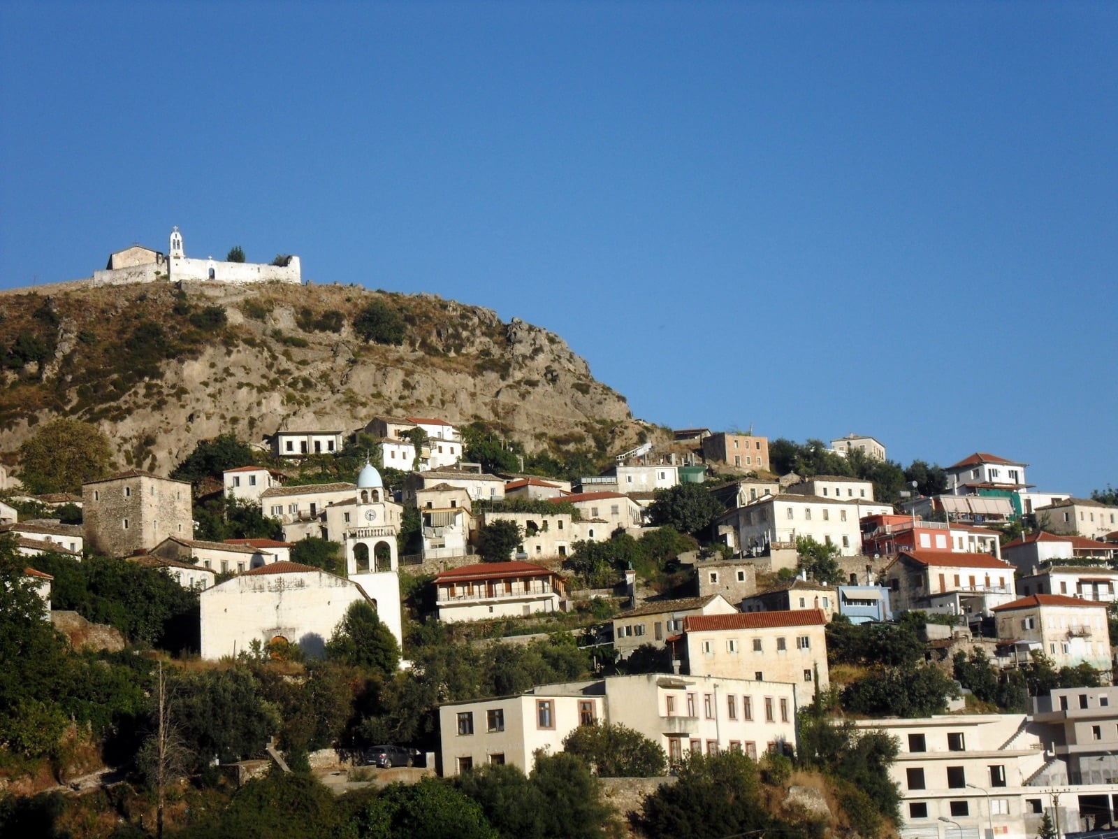 Old village of Dhërmi, Albania, with stone houses and churches climbing the hillside