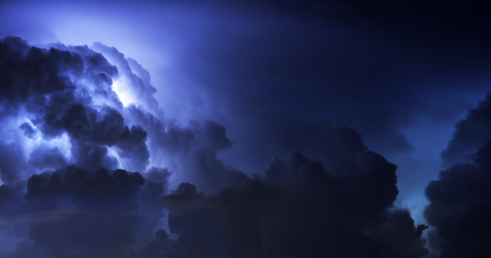 Lightning inside dark storm clouds at night, the setting of the drangue legend in Albanian mythology