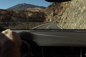 Driving through a mountainous landscape on a sunny day