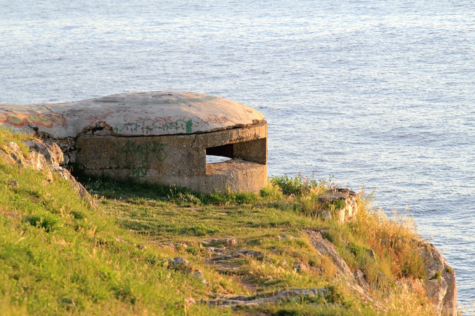 Concrete bunker on the coast overlooking the water, one of the bunkers built in communist Albania