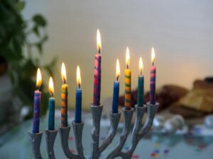 Menorah with colorful lit candles