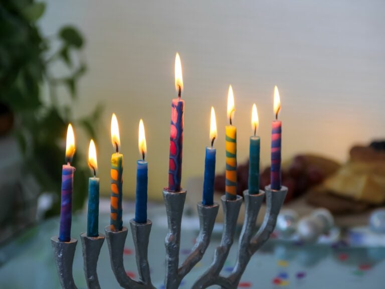 Menorah with colorful lit candles