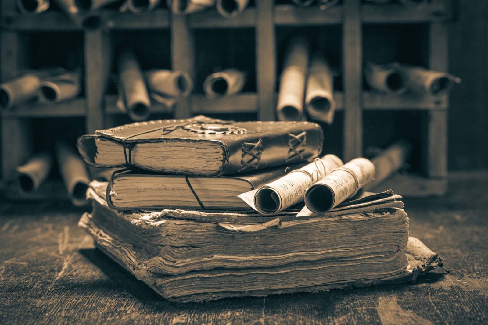 Vintage books and scrolls stacked on a wooden shelf, evoking the writers of the Albanian National Awakening