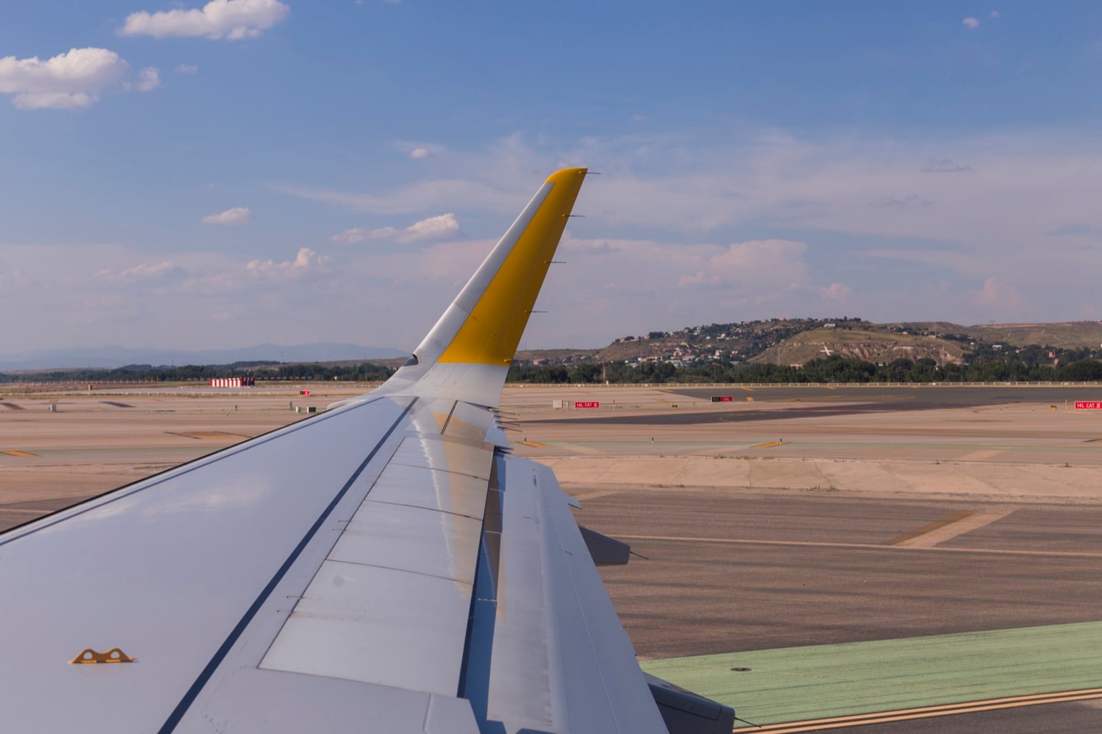 View over an airplane wing at an airport